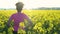 Mixed race African American girl teenager female young woman runner resting after jogging in field of yellow flowers