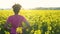 Mixed race African American girl teenager female young woman runner resting after jogging in field of yellow flowers