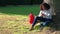 Mixed race african american girl teenager using phone by a tree