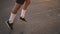 Mixed race athlete runner feet in white socks running on treadmill closeup on shoe