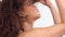 Mixed race black woman with freckles and curly hair in studio on white poses to a camera