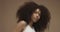 Mixed race black woman portrait with big afro hair, curly hair