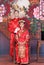 Mixed Race Bride and Groom in Studio wearing traditional Chinese wedding outfits