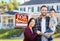 Mixed Race Chinese and Caucasian Parents and Child In Front of Home