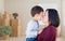 Mixed Race Chinese Mother and Child in Empty Room with Packed Mo