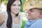 Mixed Race Country Couple with Cowboy Hat Flirting in Park