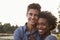 Mixed race couple in the countryside, looking to camera