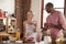 Mixed race couple drinking homemade smoothies in kitchen