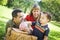 Mixed Race Couple Give Their Son a Piggy Bank at the Park