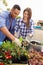 Mixed Race Couple Planting Rooftop Garden Together