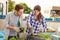 Mixed Race Couple Planting Rooftop Garden Together