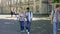 Mixed-race couples of students walking at university courtyard after classes