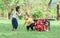 Mixed race diverse kids playing together with funny moment of cart falling down, laughing with amusement while staying outdoor in