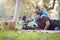 Mixed Race Ethnic Family Having Picnic In The Park