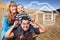 Mixed Race Family at Construction Site with Ghoosted House Behind