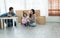 Mixed race family playing balloon together. Young Caucasian father with beard and Asian mother playing blocks toy and blow balloon