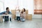 Mixed race family playing balloon together. Young Caucasian father with beard and Asian mother playing blocks toy and blow balloon