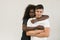 Mixed race family. Young tender wife hugging his husband. Loving