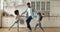 Mixed race father and children dancing together in modern kitchen