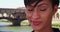 Mixed race female traveling in Florence smiling at camera near Ponte Vecchio