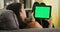 Mixed race girl looking at tablet with green screen