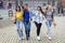 Mixed race group of attractive young women smiling, hugging and walking in the city center of Antwerp. urban lifestyle