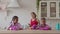 Mixed race kids helping mom doing household chores