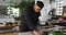 Mixed race male chef kneading dough on a kitchen table