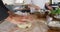 Mixed race male chef kneading dough on a kitchen table