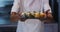 Mixed race male chef standing in kitchen making a nice plate of sushi