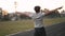 Mixed race man athlete warming up doing jumping jacks before running or work out