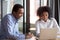 Mixed-race mentor manager consulting african client teaching employee with laptop