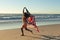 Mixed race patriotic woman running with american flag on the beach