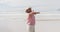 Mixed race senior woman spinning with open hands at the beach