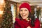 Mixed Race Teen Wearing Mittens and Hat In Christmas Setting