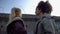 Mixed-race teenage friends looking at barbed wire fence, refugee camp, hope