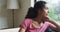 Mixed race thoughtful woman, sitting living in room