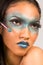 Mixed race woman advertising exotic blue make up