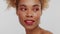 Mixed race woman with big curly afro blonde hair in studio