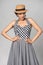 Mixed race woman in chequered summer dress and canotier straw hat