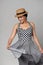 Mixed race woman in chequered summer dress and canotier straw hat