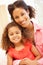 Mixed race woman and daughter at home