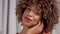 Mixed race woman on grey curtains background closeup portrait making faces and move her head