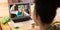 Mixed race woman having st patrick\'s day video call with happy female friend on laptop at home