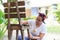 Mixed race woman painting chair in home