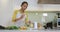 Mixed race woman preparing healthy drink in kitchen