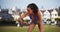 Mixed race woman runner looking at her fitness watch at the park