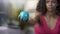 Mixed-race woman squeezing ball in hand, training arms, muscles strength