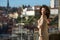 Mixed-race woman on a street in old Porto downtown near Dom Luis I bridge.