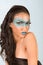 Mixed race woman wearing exotic blue make up